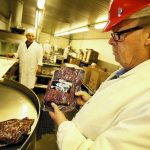 Jerry Haines, general manager of R.C. Provision in Burbank, holds pastrami that's ready for shipping. The company, which supplies Pink's, Langer's Delicatessen and other eateries, is struggling as beef prices have hit a record high in the U.S. (Al Seib, Los Angeles Times / March 28, 2014)