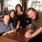 family posing in the diner