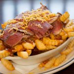 chili cheese fries topped with pastrami