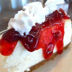 cheesecake with strawberry topping and whipped cream