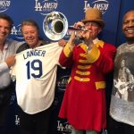 Norm Langer holding up a Dodgers jersey with his name on it